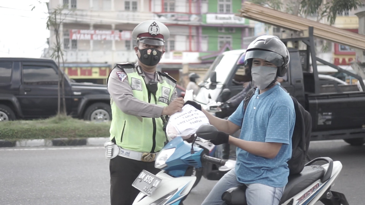 Mantap !! Polsek Tampan Bagikan Sembako Bagi Pengendara yang Pakai Masker